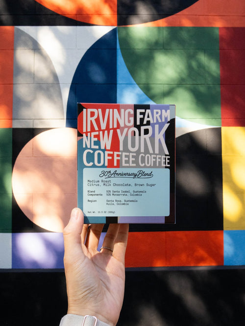 30th Anniversary Blend box held up in front of a New York mural