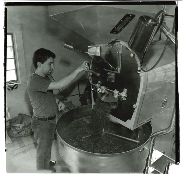 Black and white photo of Steve working the coffee roaster