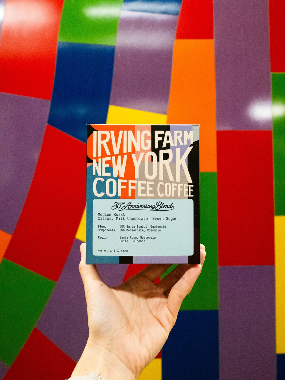 30th Anniversary Blend box held up in front of a New York mural
